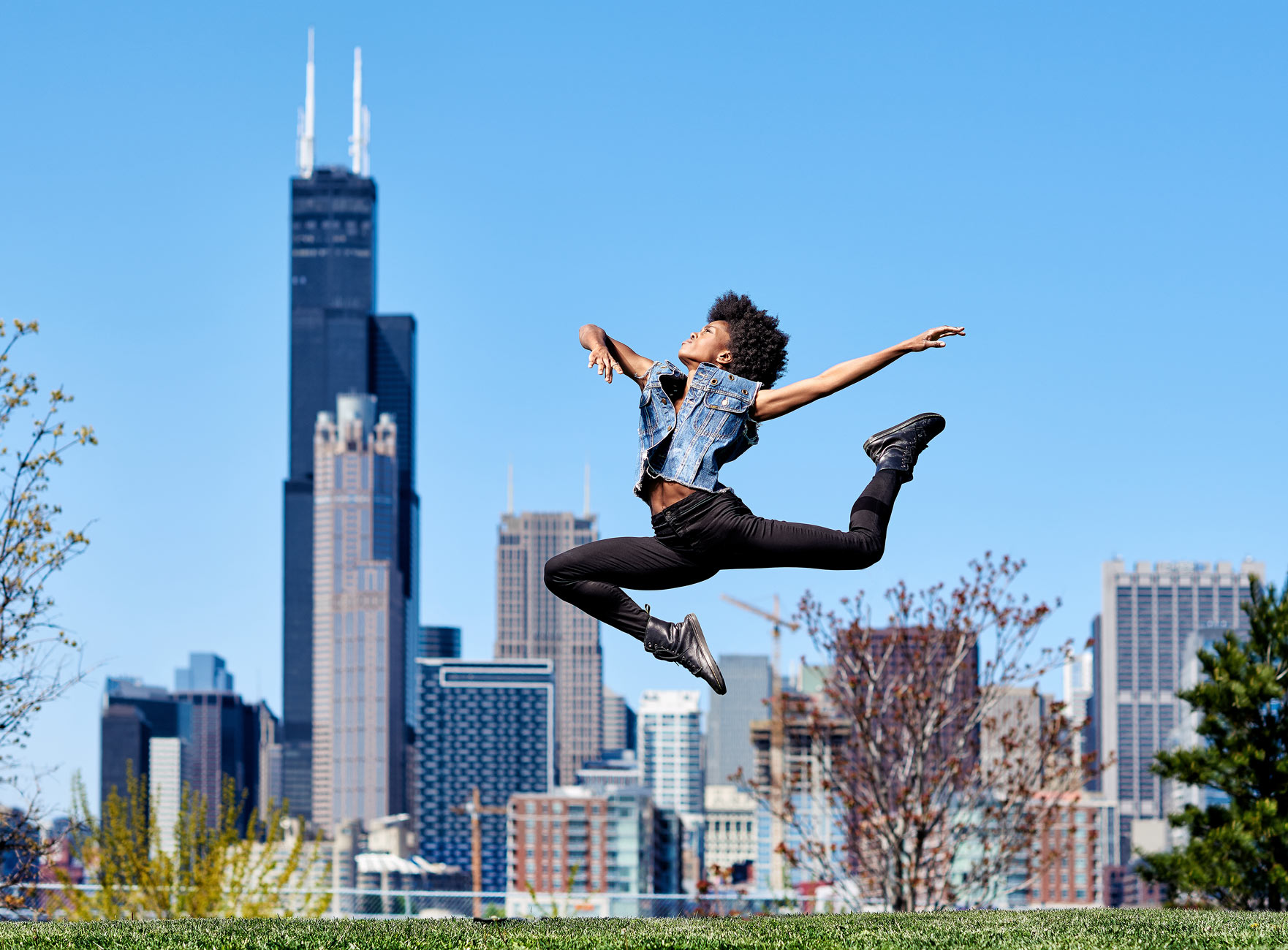 Dancer jumping with the Sears tower in background in Chicago.