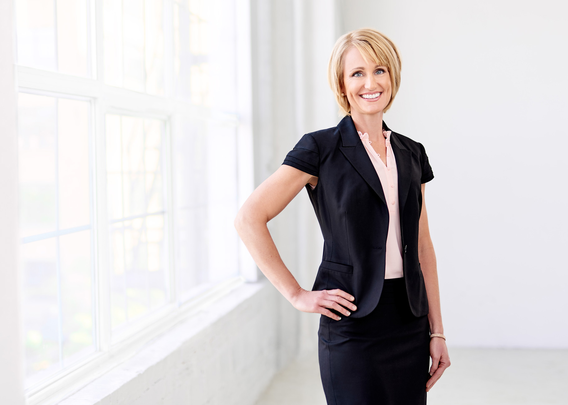 Corporate portrait of woman next to window in St. Louis