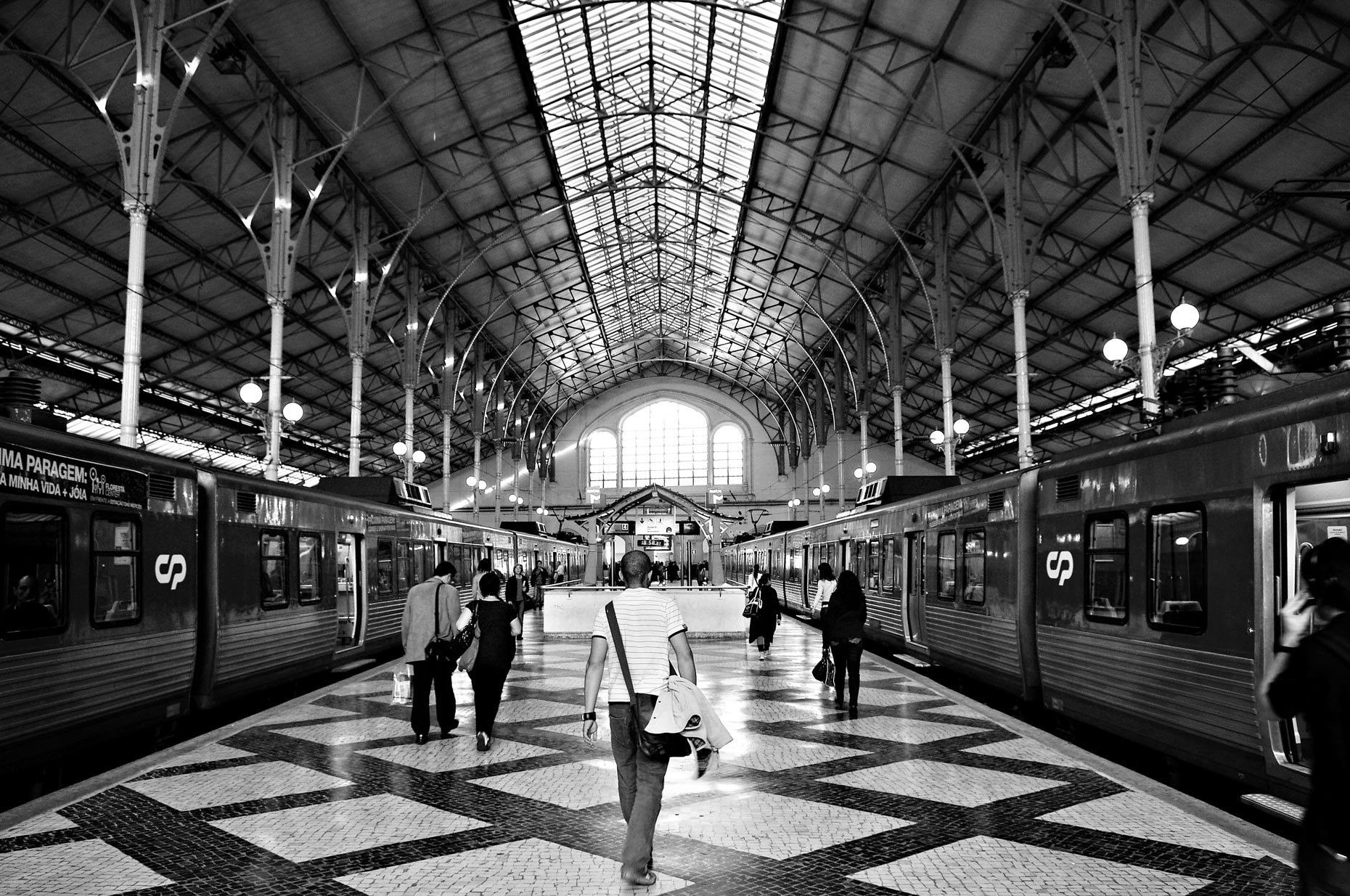 Passengers walking inside train station in Lisbon Portugal.